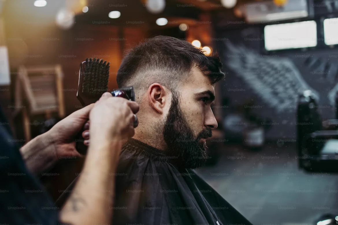 Barber blending a fade with clippers at A-Z Barbers Cardiff